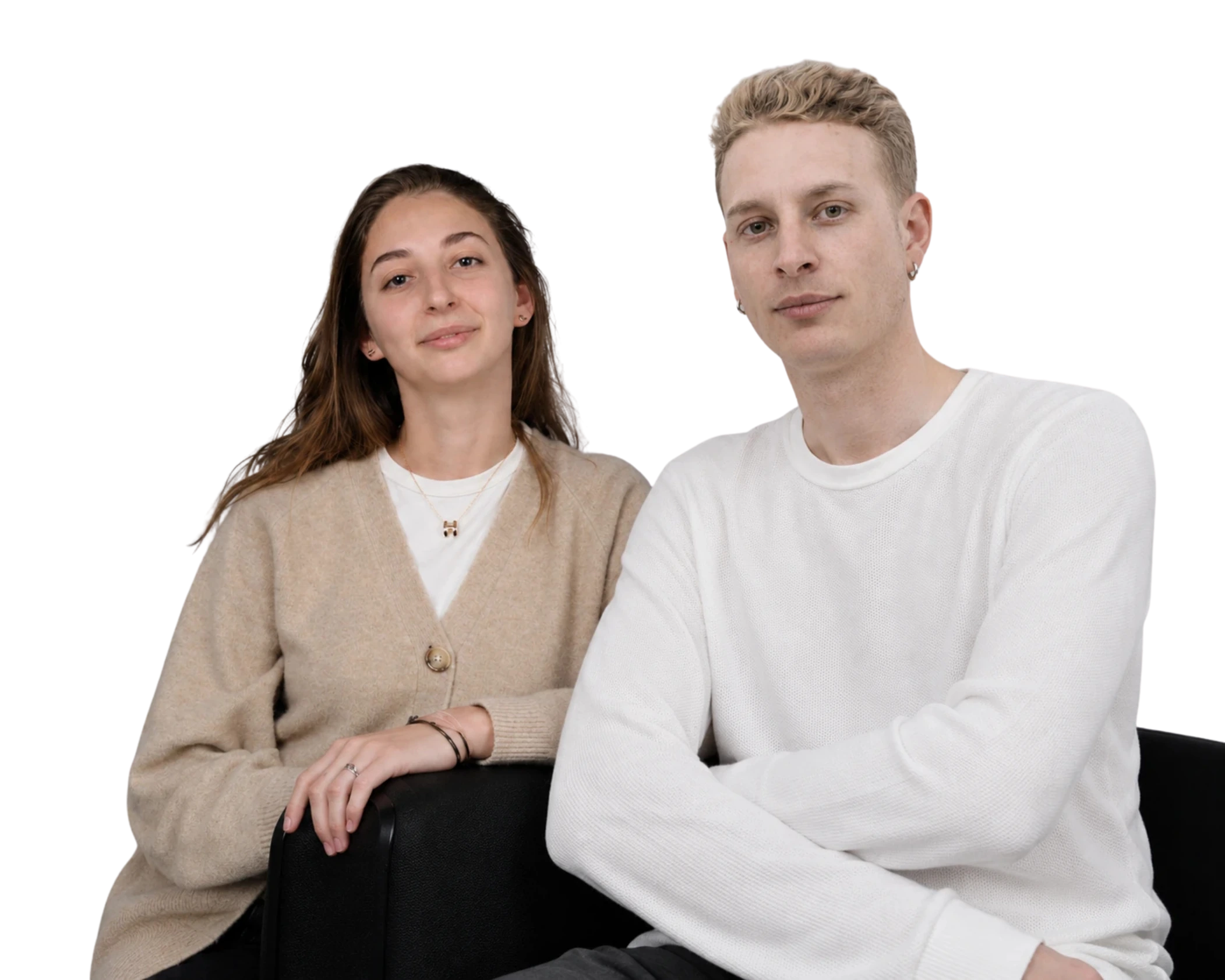 Jeune femme en gilet beige et homme blond en pull blanc assis cote a cote, regardant l'objectif